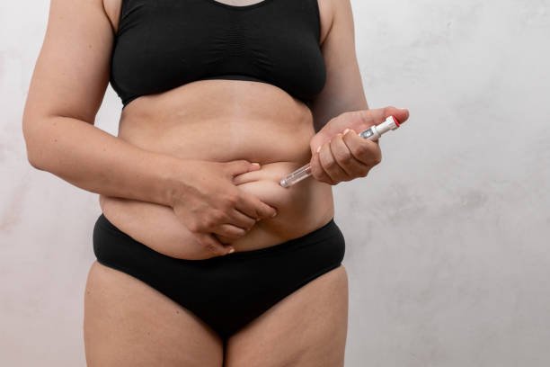 a person in underwear holding a ozempic injection